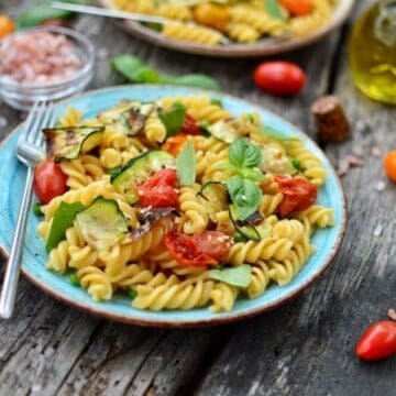 Blue plate filled with easy summer pasta salad.