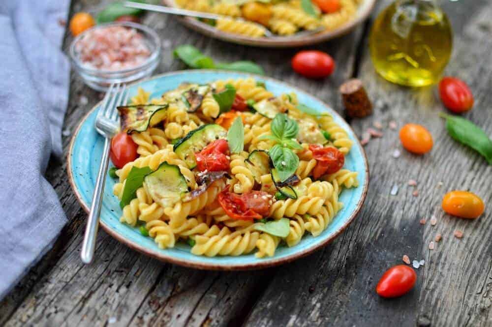 Blue plate filled with easy summer pasta salad.