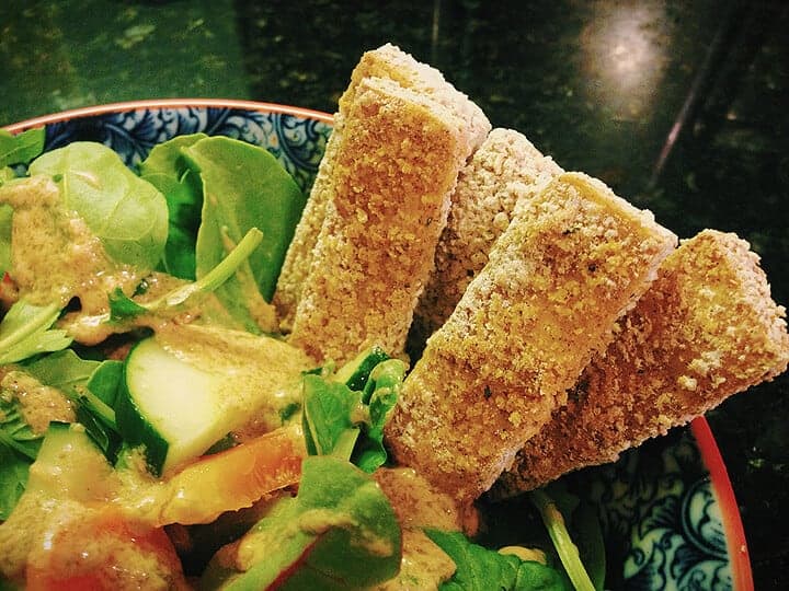 Crispy tofu nuggets tucked into a fresh green salad.