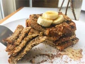 A fork picking up a bite of vegan crunchy french toast.