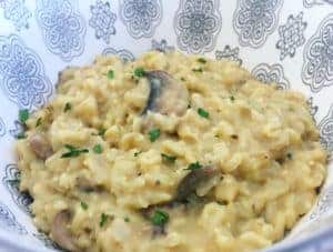 A patterned bowl full of creamy brown rice risotto.