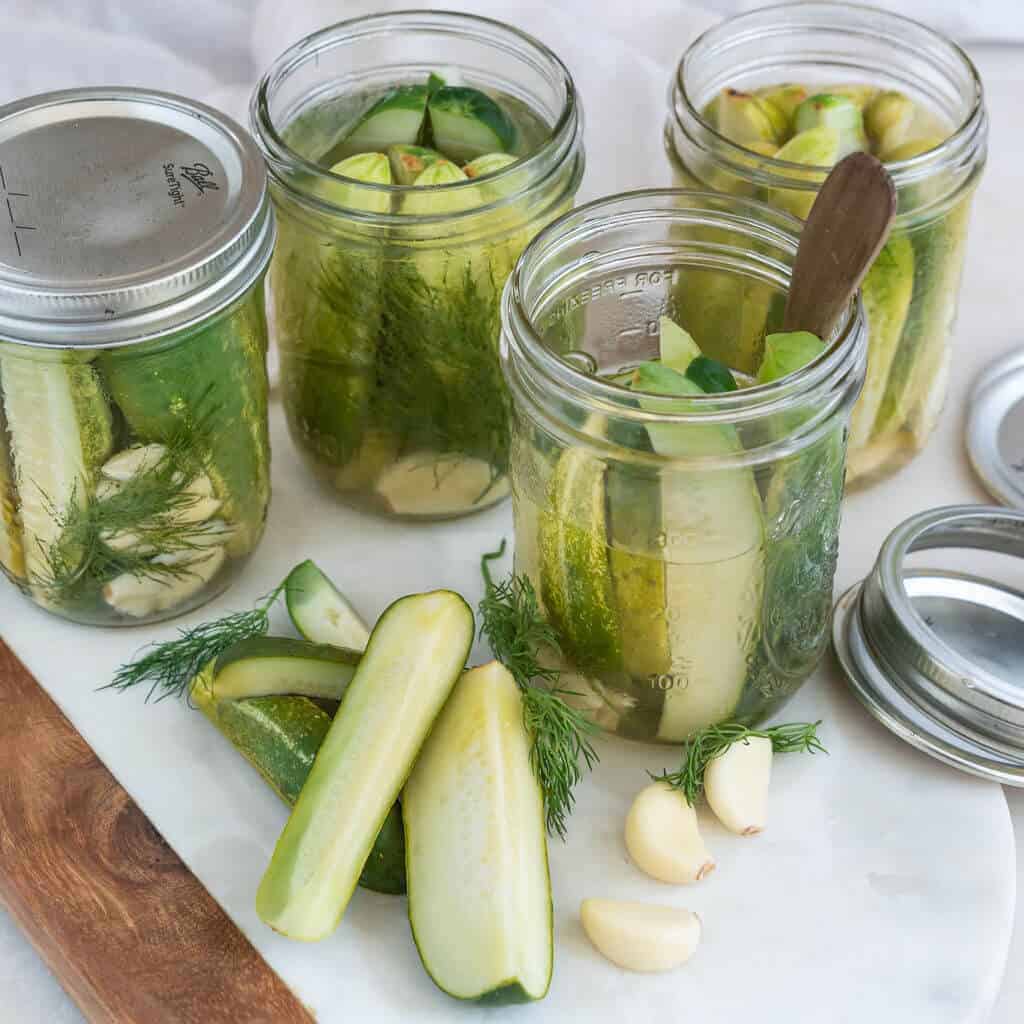 Garlic Dill Pickles packed in canning jars.