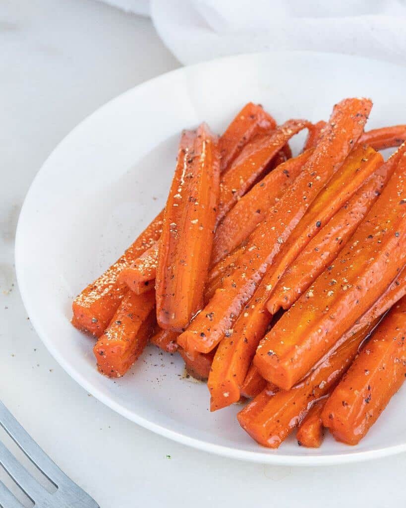 Glazed Carrots on a white plate in a white background
