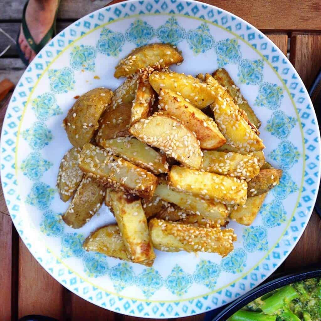Oven baked sesame fries on a blue plate.