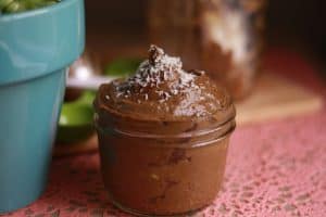 Vegan chocolate avocado pudding in a small mason jar.