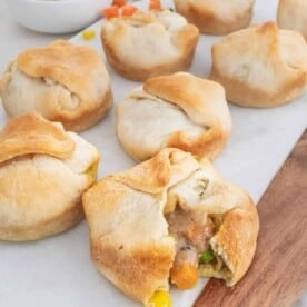 Mini vegan pot pies set out on a white board.