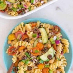 A blue bowl with a large helping of perfect veggie pasta salad.