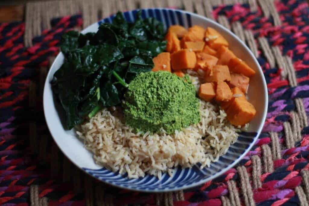 A dollop of parsley pesto in the middle of rice and veggies.