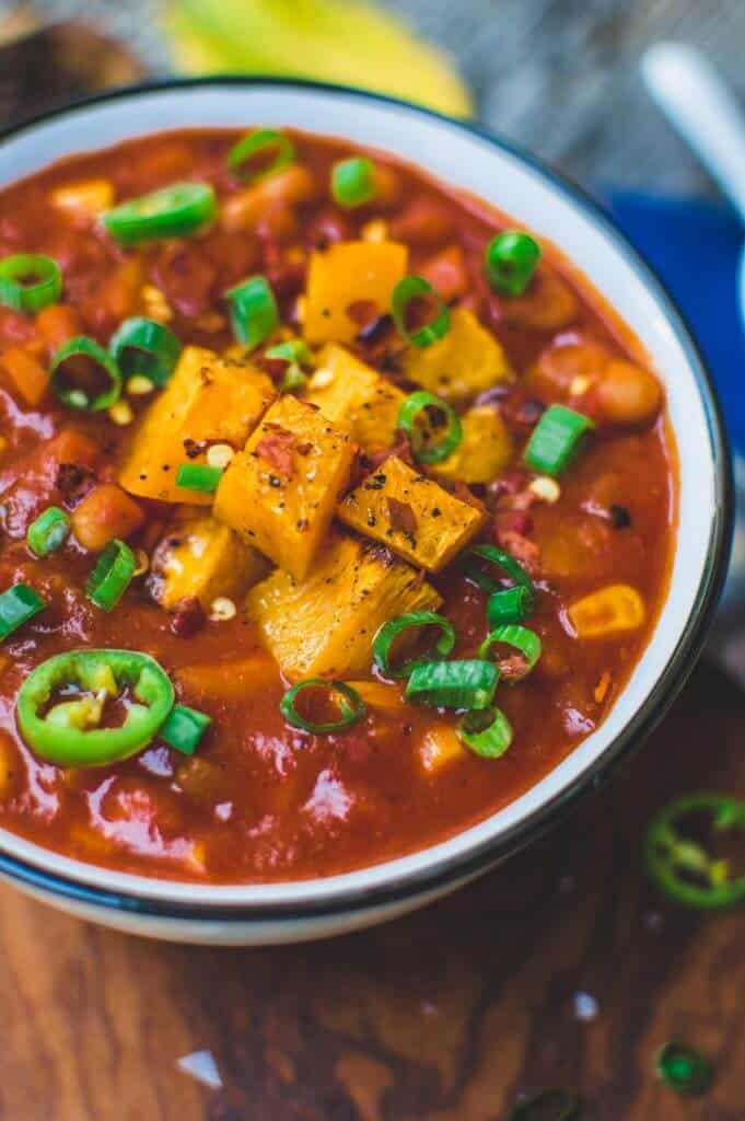 pumpkin chili in a bowl against a brown surface