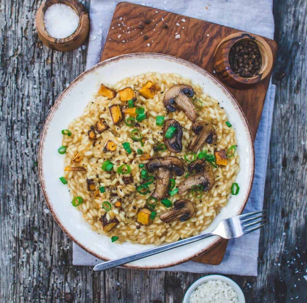 Pumpkin Risotto on a white plate against a gray background