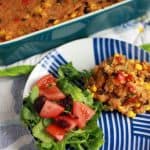 Quinoa casserole and green salad on a plate.