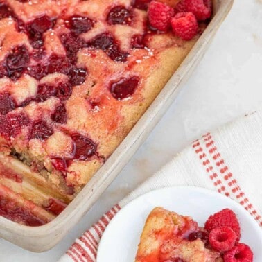 Raspberry bread pudding in a square baking dish.