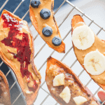 Sweet potato "toast" slices topped with nut butter and fruit.