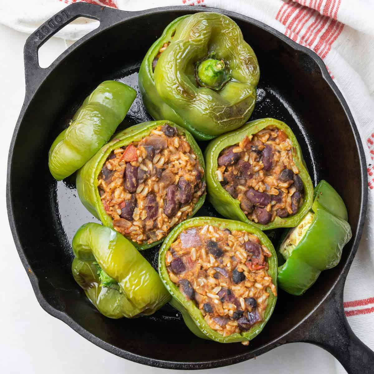 Southwest stuffed green bell peppers in a case iron skillet.