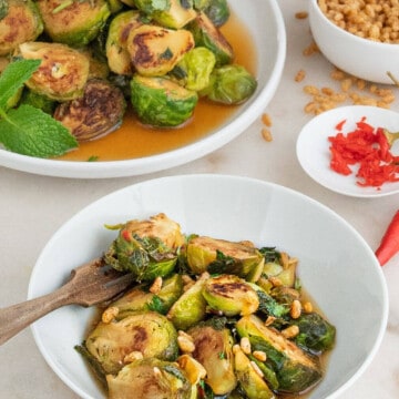 A serving of spicy mint brussels sprouts in a white bowl.