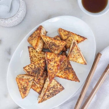 completed Sweet and salty tofu triangles on a white platter against a white background