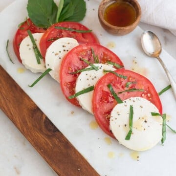Tomato and Silken Tofu caprese salad on a white platter