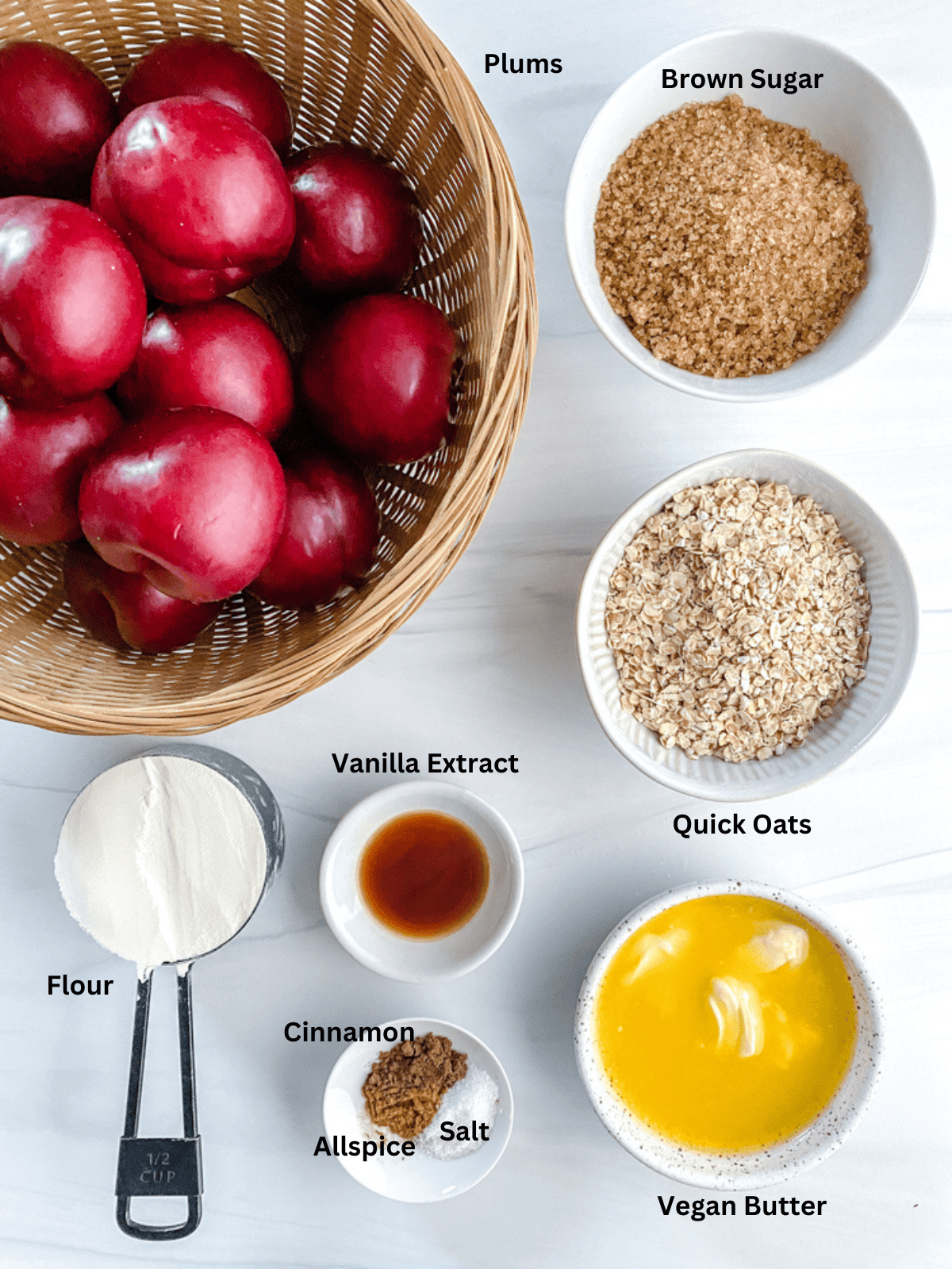 Ingredients for Vegan Plum Crisp measured out on a white surface.