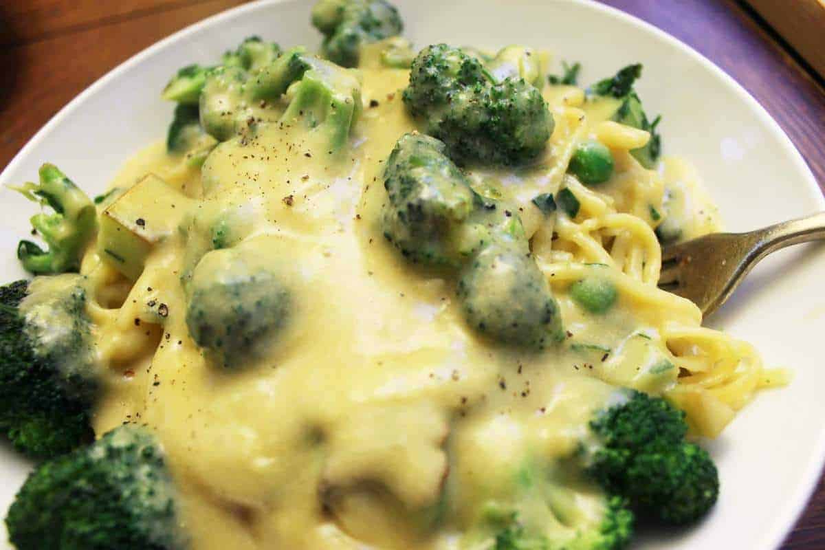 Vegan alfredo sauce over broccoli and pasta.