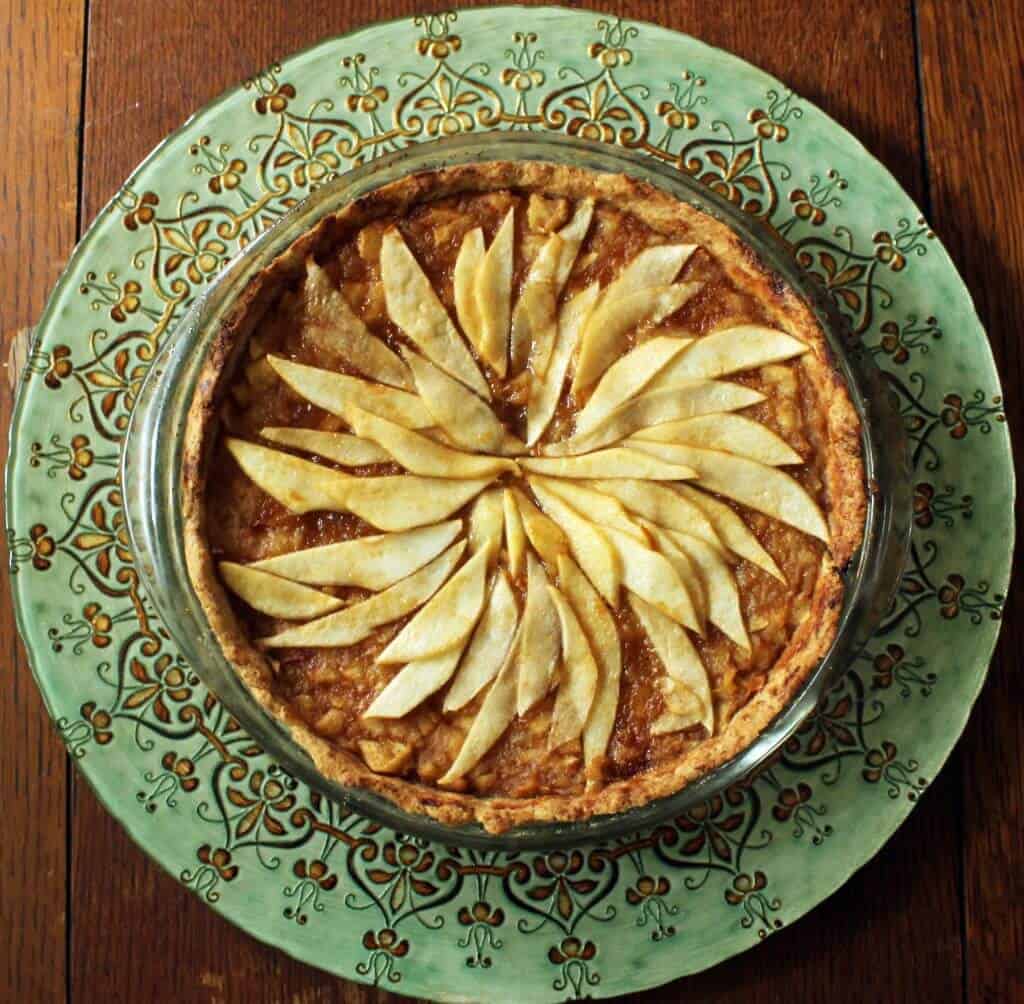 Apple pear tart on a green serving stand.