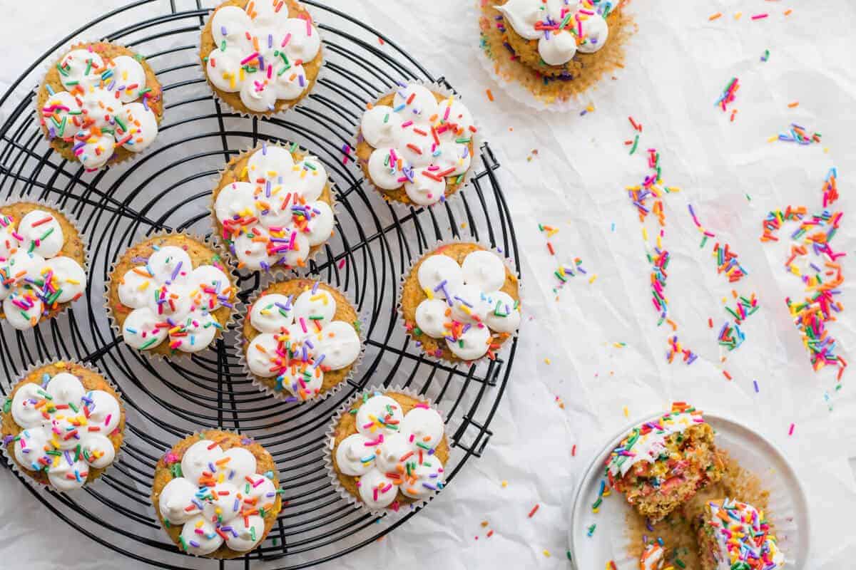 Cooling Rack with Colorful Funfetti Cupcakes on Top , on a white marble surface
