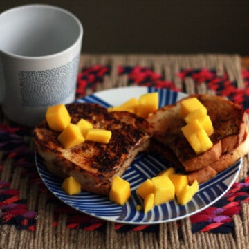 French toast and fruit on a patterned plate.