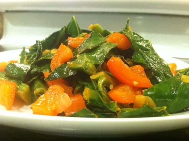 Spicy collard greens and peppers mounded on a plate.