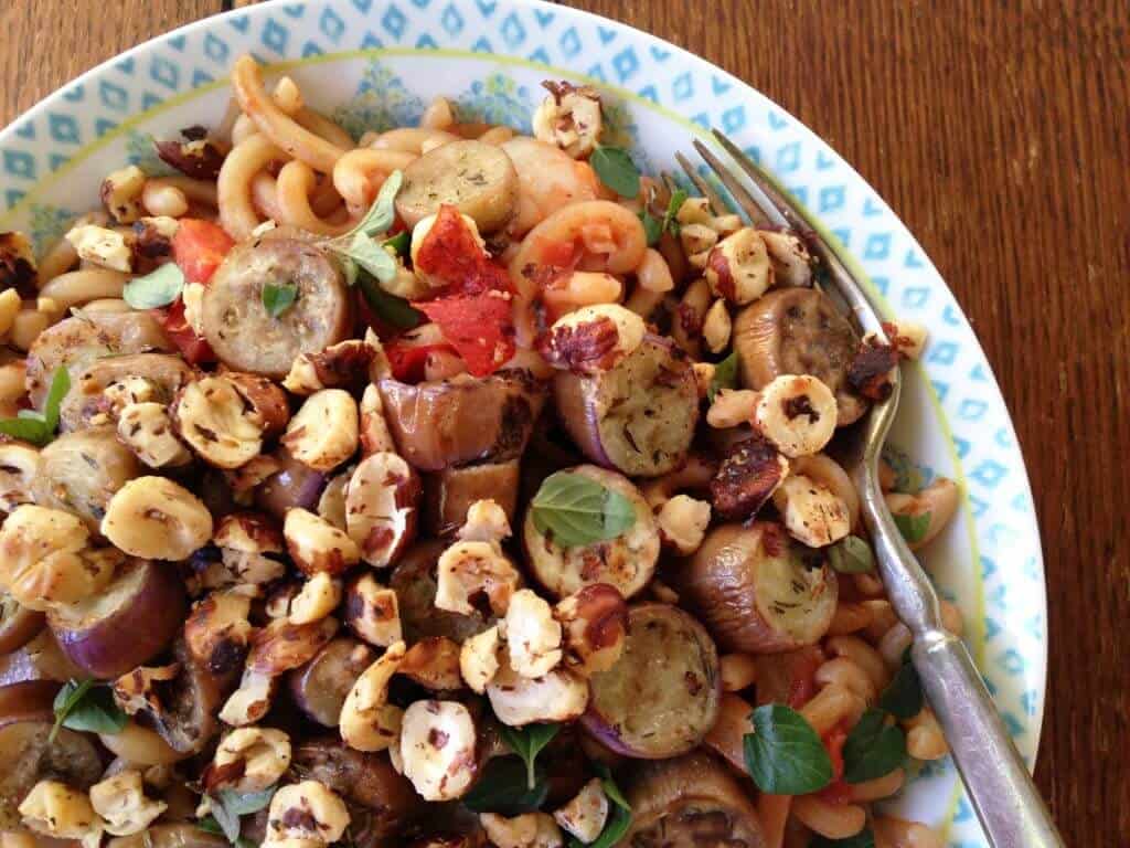 Hazelnut eggplant pasta in a bowl with a fork.