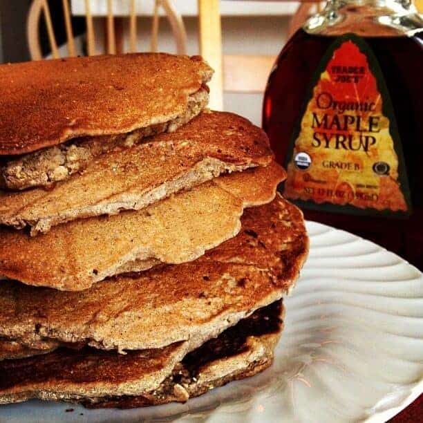 A stack of buckwheat pancakes on a white plate.