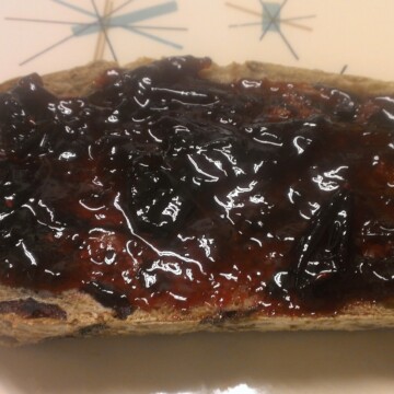 Vegan Plum jam spread on a slice of toast.