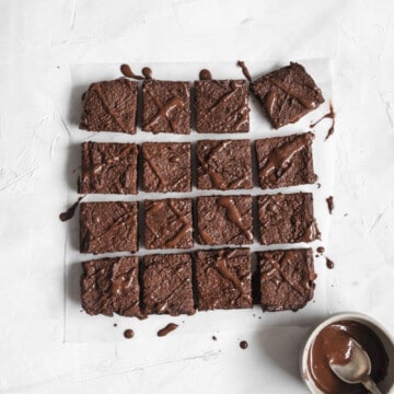 A square pan of pumpkin chocolate brownies cut into squares.