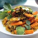Sweet potato and turmeric fried rice in a white bowl.