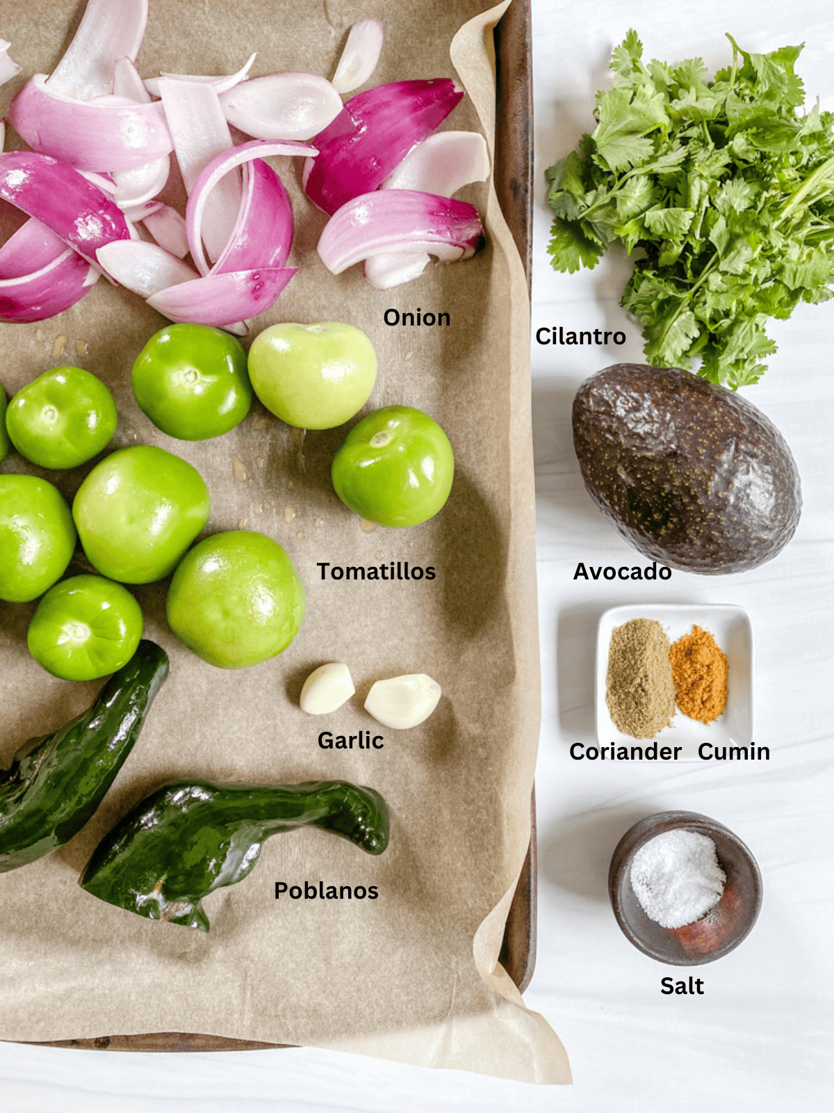 Ingredients for Creamy Tomatillo Avocado Salsa Verde measured out on a white surface.