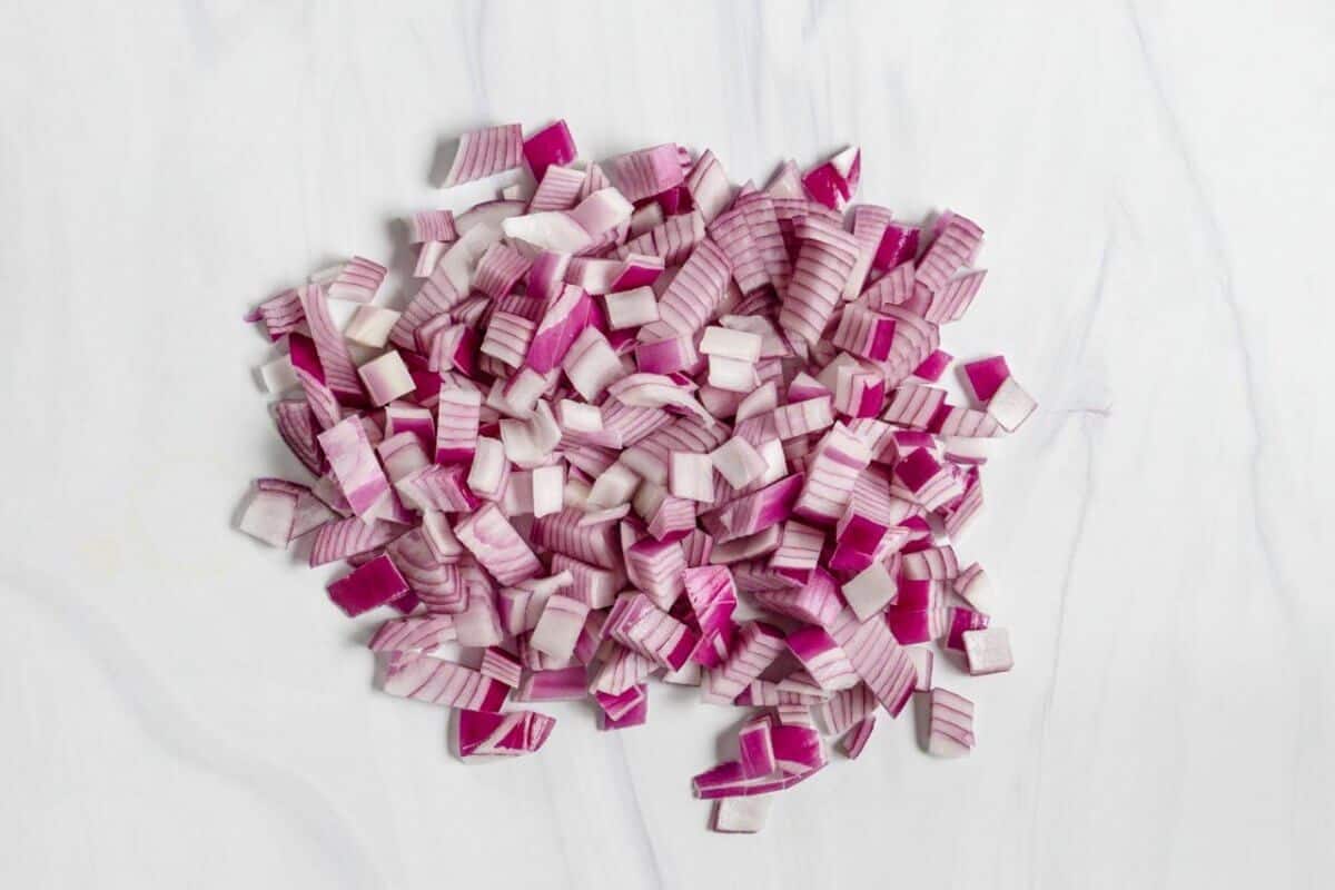 The Basics of Cutting Diced Red Onions on a Marble Surface