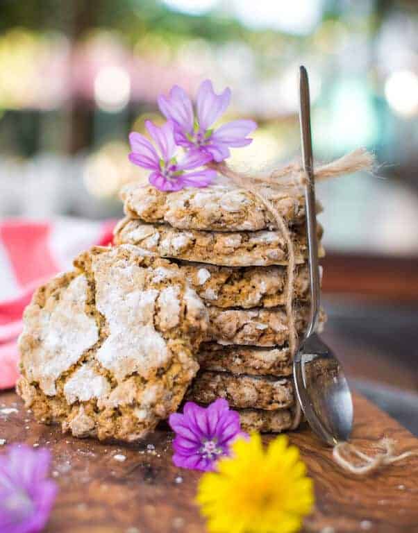 A stack of vegan oatmeal crinkle cookies on a wood table.