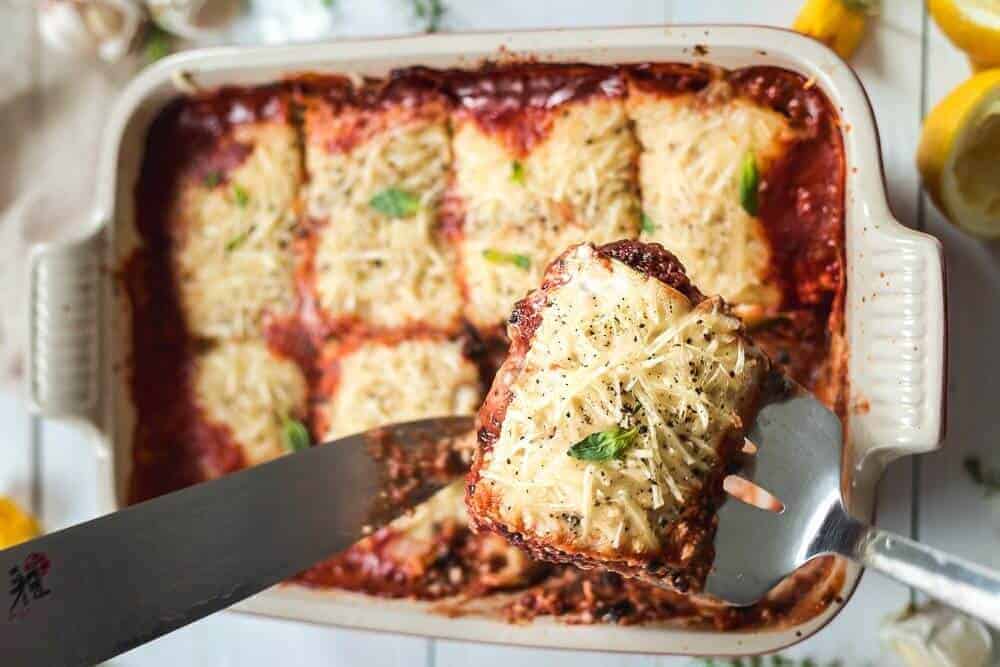 vegan lasagna that is precut in a light colored tray