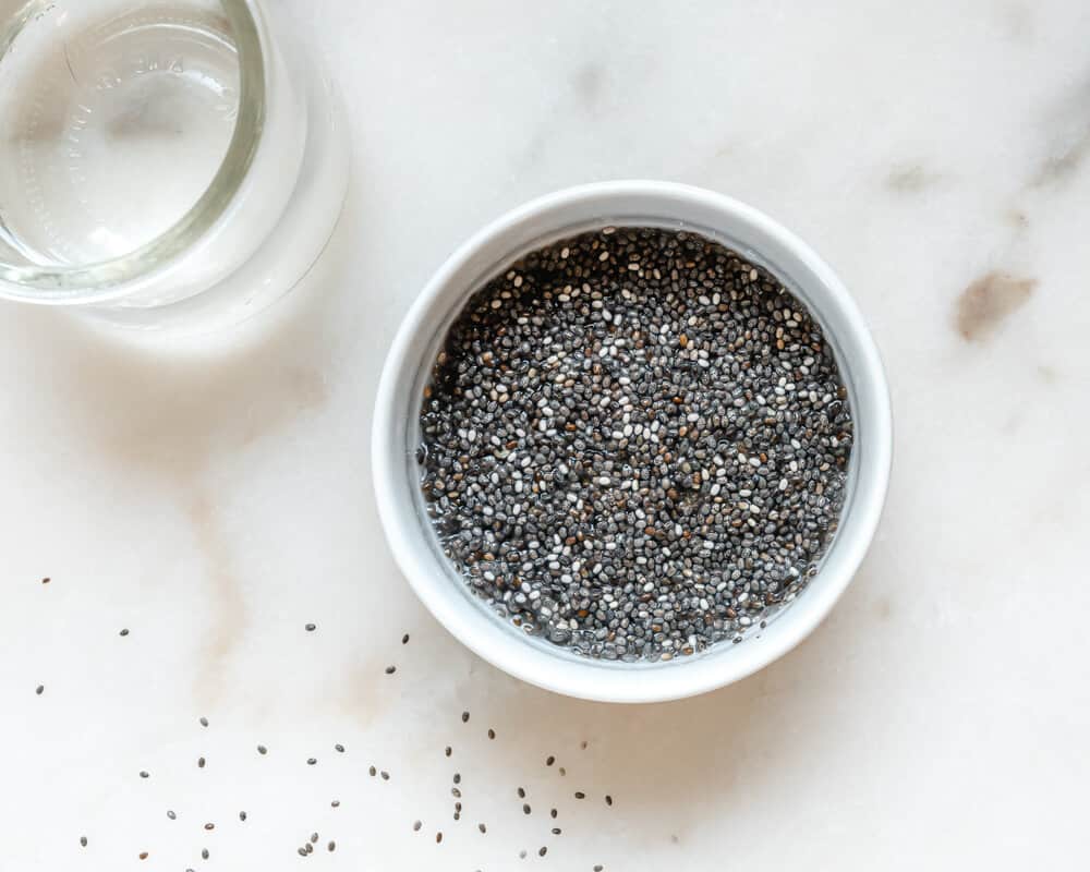 Bowl of Activated Chia seeds and a glass of water 