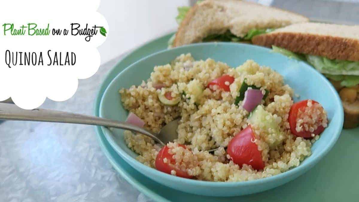 A blue bowl filled with quinoa veggie salad.