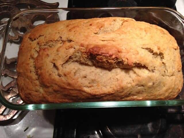 Top view of a loaf of baked banana bread in a glass pan.