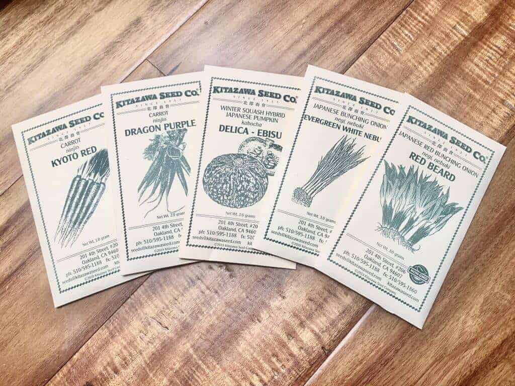 Kitazawa Seed Co packets spread out on a wood table.