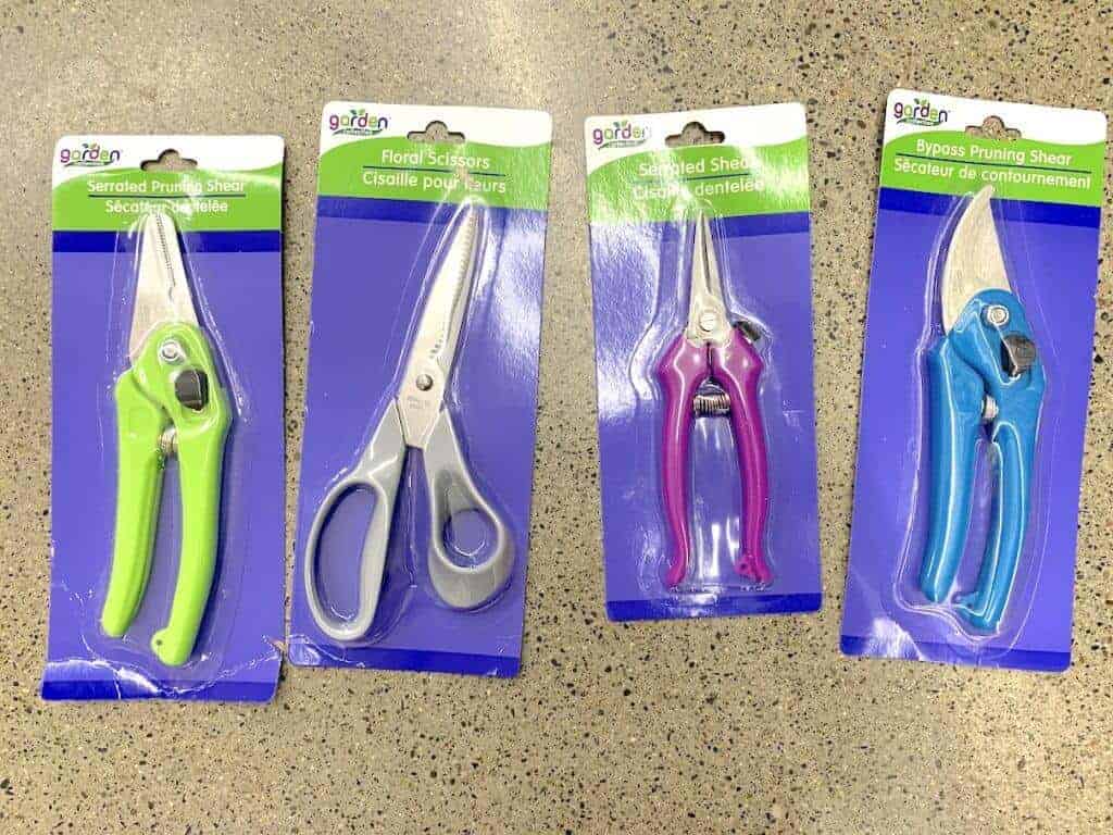 Four different garden shears in packages.