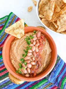 A bowl of vegan pinto bean dip.