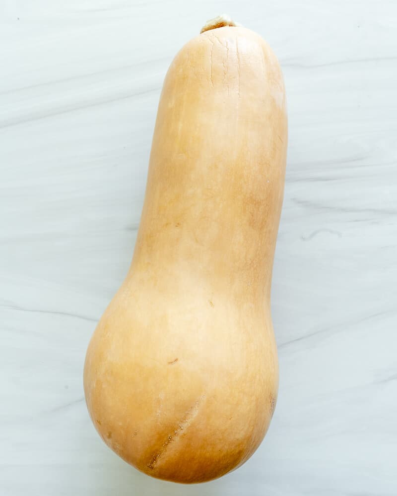 raw butternut squash against white surface