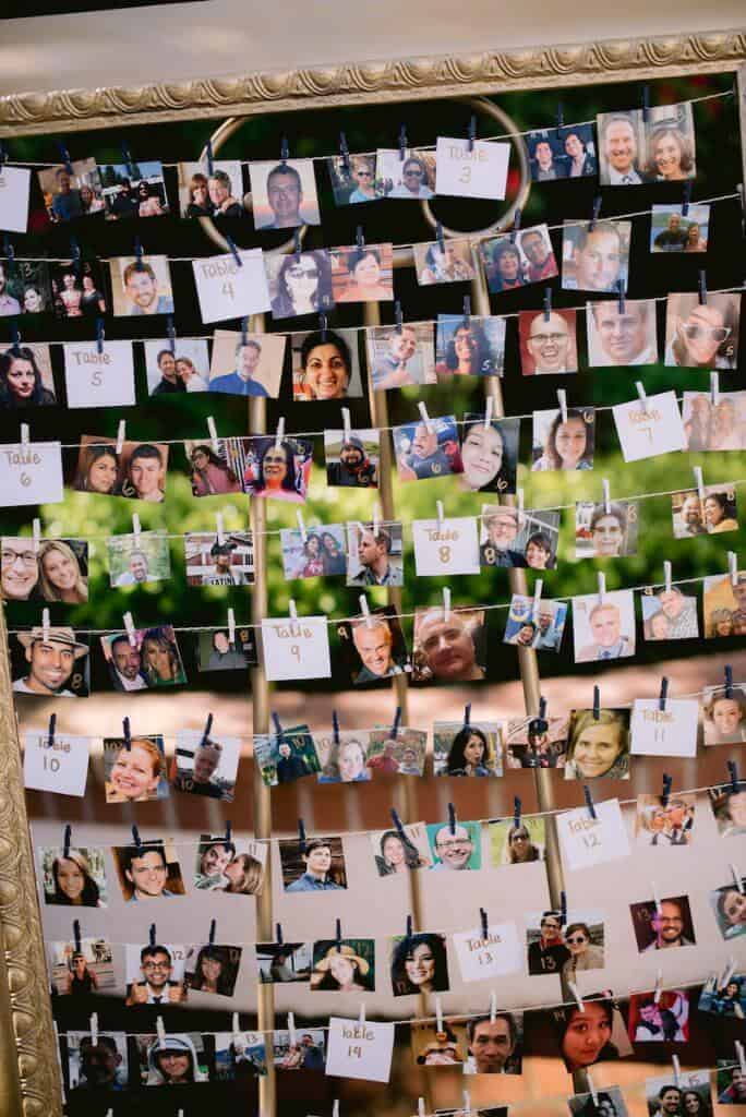 An open picture frame with photos strung across it.