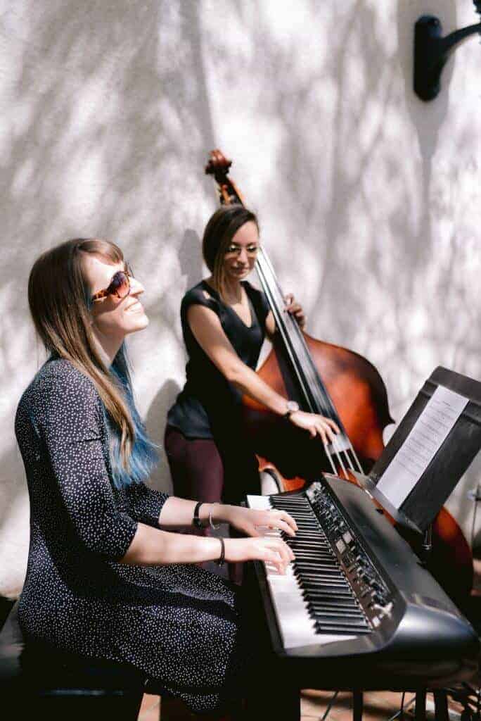 Ladies playing a keyboard and upright bass at a wedding.