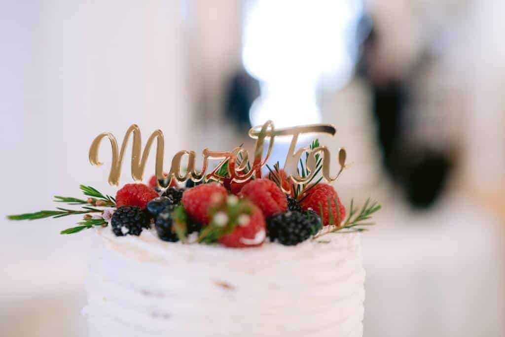Closeup of top tier of a wedding cake with fresh berries.
