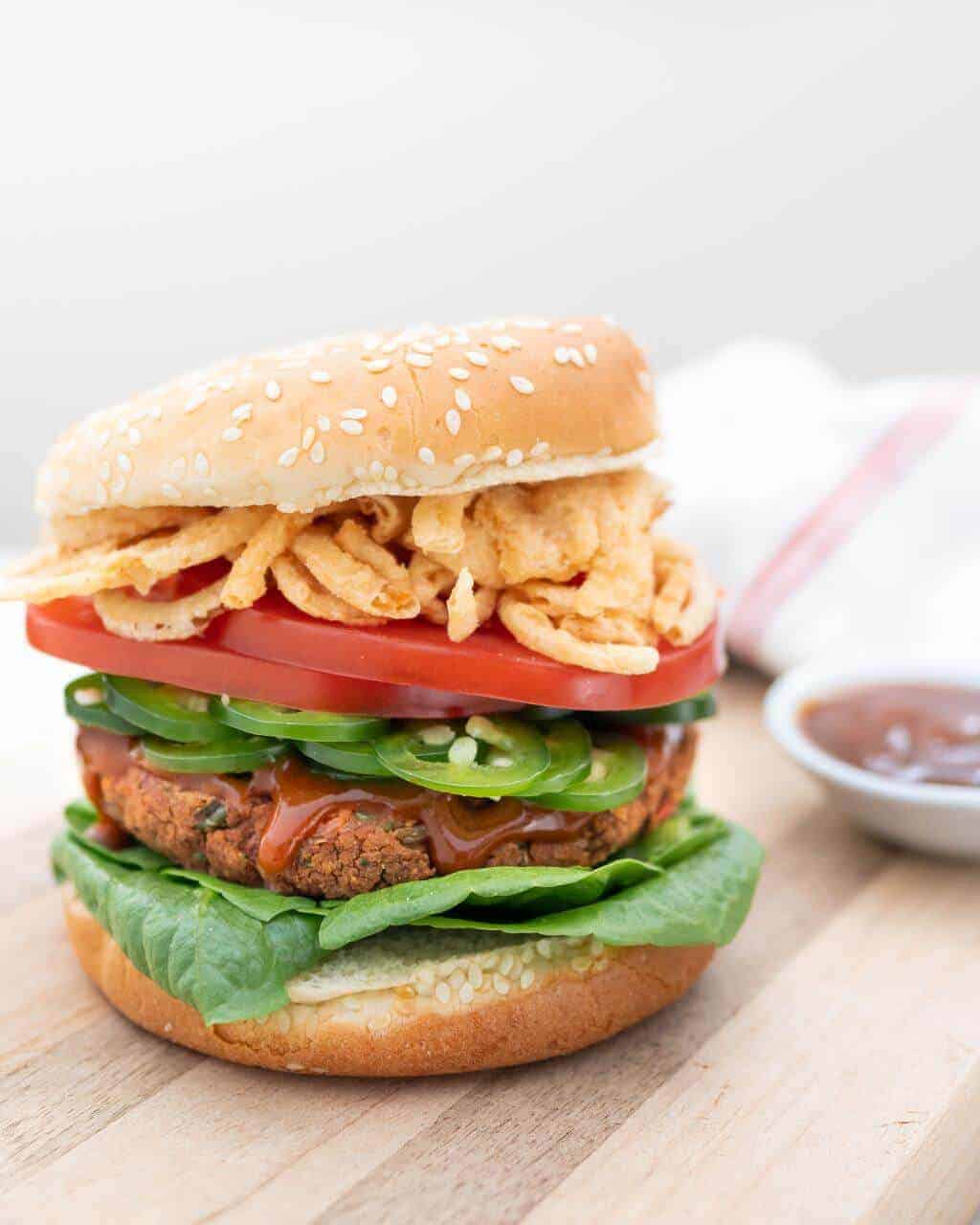 spicy red bean burger on wooden surface with white background