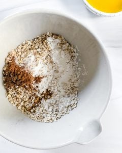 plum crisp ingredients in white bowl in white background