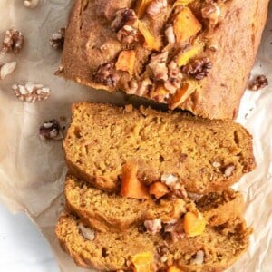 completed pumpkin bread sliced on parchment paper