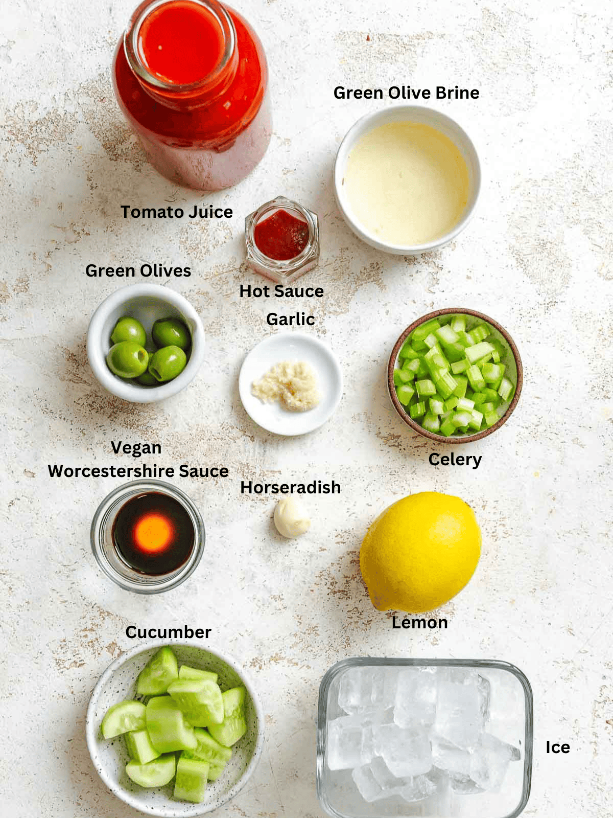 Ingredients for Virgin Bloody Mary measured out on a white surface. 